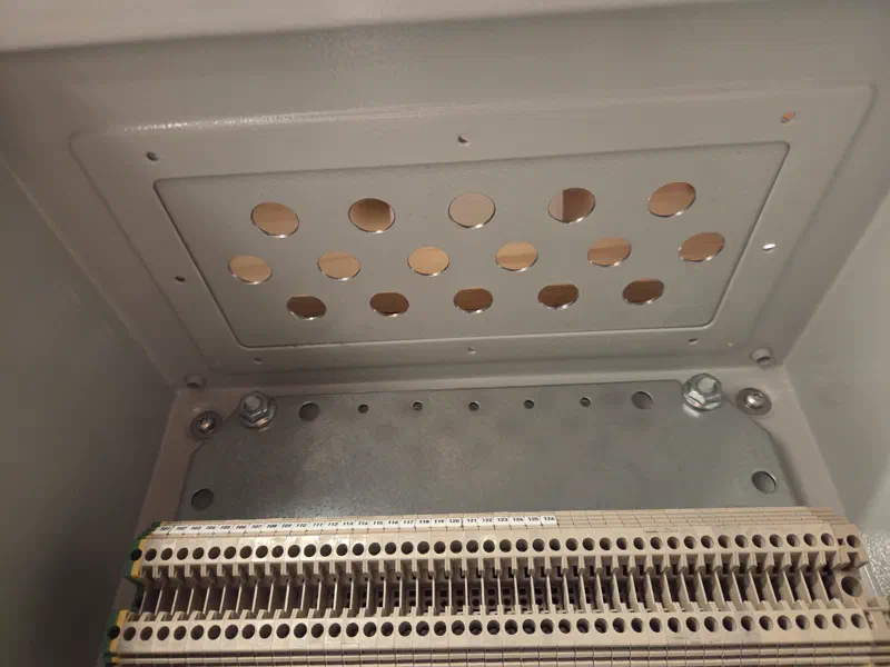 Completed cabinet gland plate with 16 cleanly drilled holes