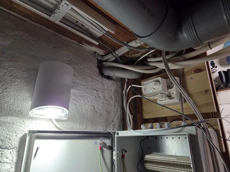 Basement ceiling with cable duct; the top of the alarm cabinet has cable glands