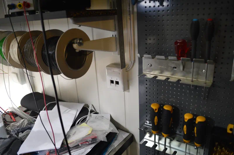 Network outlet on wall, next to wire spools and tools